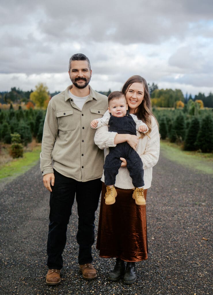 Family posing for photos at Christmas tree Farm