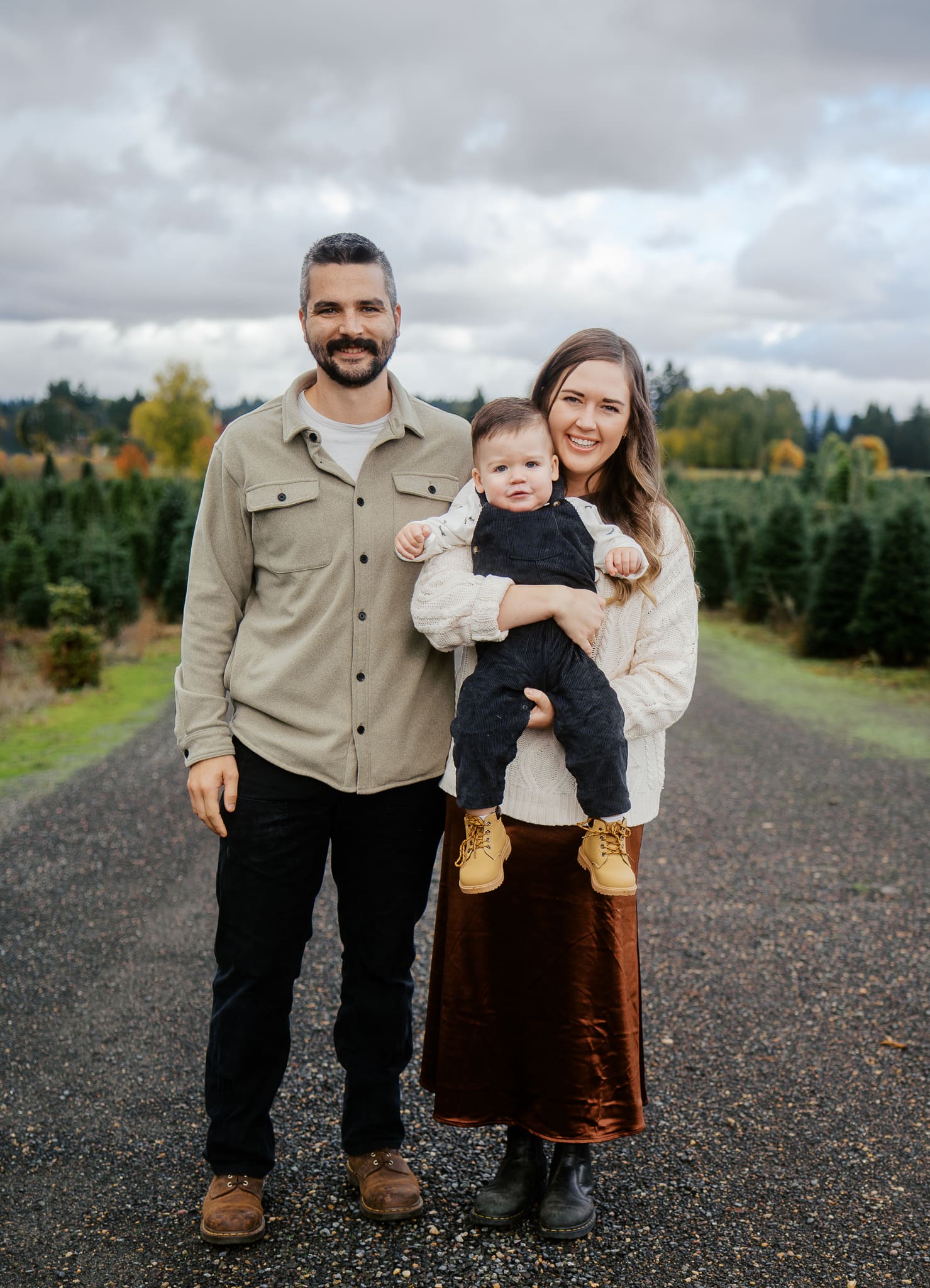 Family posing for photos at Christmas tree Farm